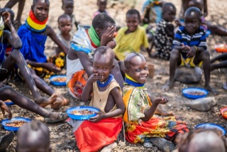 I bambini si siedono insieme per mangiare a scuola.